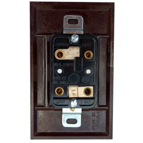 Vintage Art Deco Bakelite rocker light switch by PDL with classic black finish.