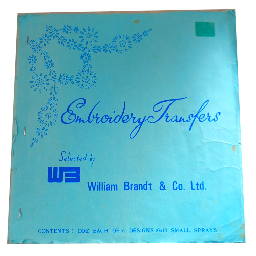 Vintage hand embroidery iron-on transfer sheet with assorted floral patterns, some transfers already used
