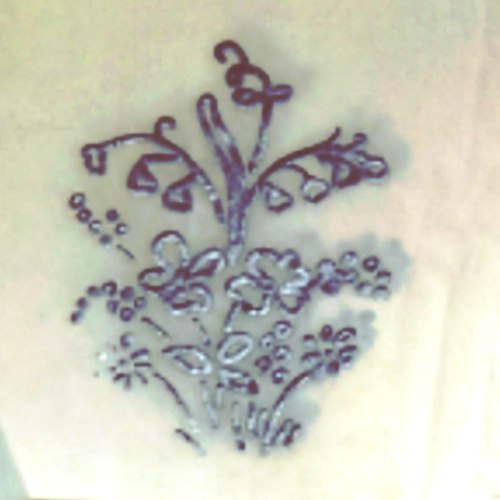 Vintage hand embroidery iron-on transfer sheet with assorted floral patterns, some transfers already used