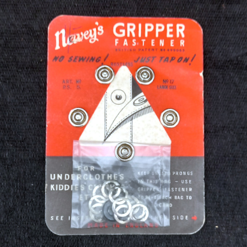 Vintage Newey's Gripper 12mm snap fasteners with five fasteners attached to the original retail packet.