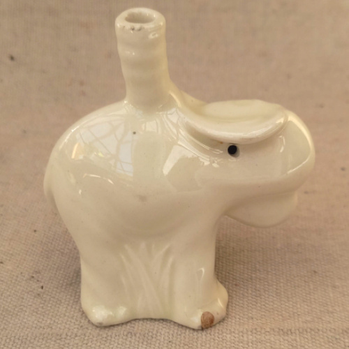 Vintage Nutbrown ceramic elephant pie funnel with a small chip on the right front foot.