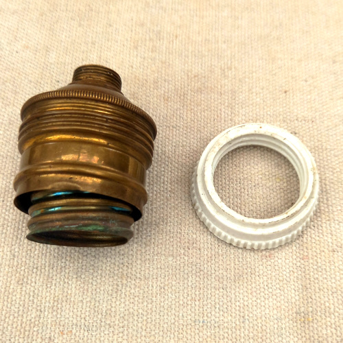Vintage E27 brass and porcelain lamp socket for antique and industrial lighting restoration.