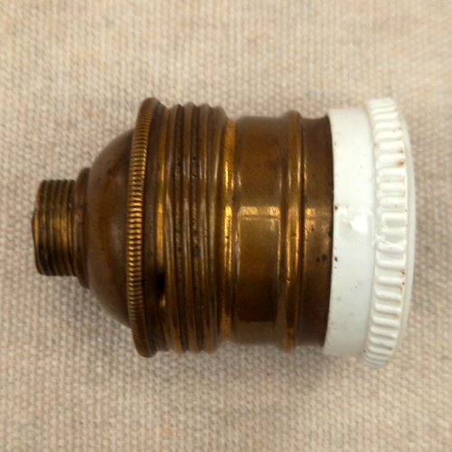 Vintage E27 brass and porcelain lamp socket for antique and industrial lighting restoration.