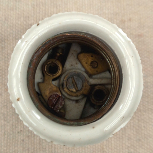 Vintage E27 brass and porcelain lamp socket for antique and industrial lighting restoration.