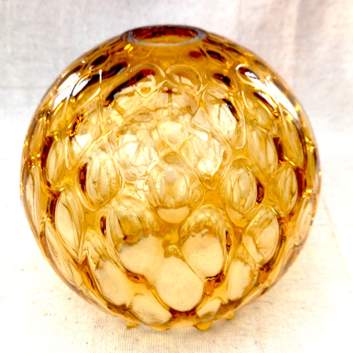 Retro globe pendant light shade made from textured amber glass with a warm vintage finish.
