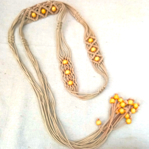 Authentic 1970s hand-knotted macramé belt in natural fiber with vintage bohemian styling.