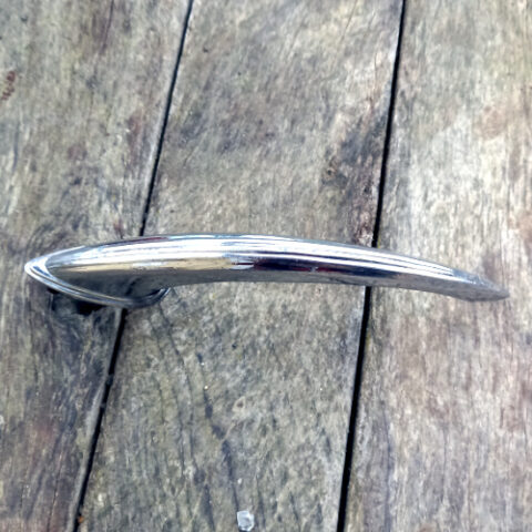 Vintage chrome automotive exterior door handle marked Industria Argentina