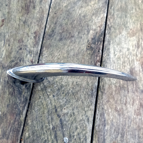 Vintage chrome automotive exterior door handle marked Industria Argentina