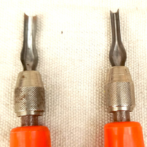 Two Speedball lino cutter handles with blades and storage compartments