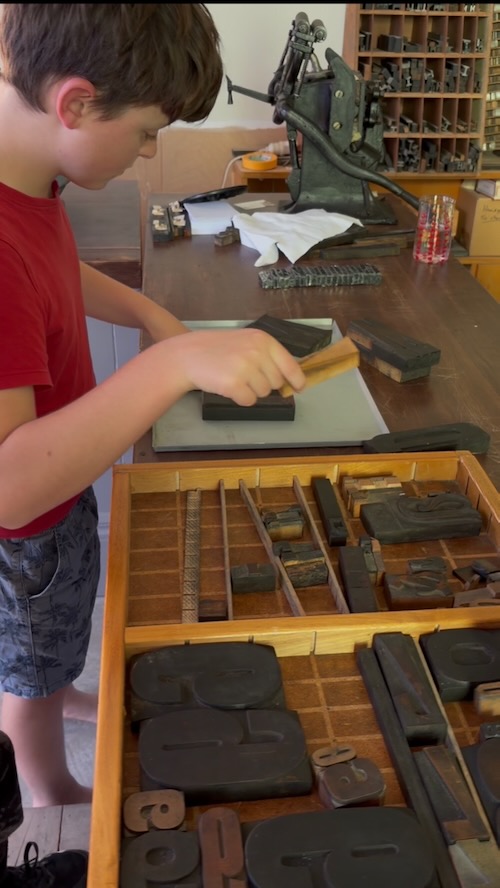 Family-friendly printing activity using the historic 1875 Albion Press at Willow Bank.