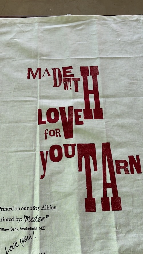 Handmade tea towel with a personalised printed design created using the historic Albion Press.