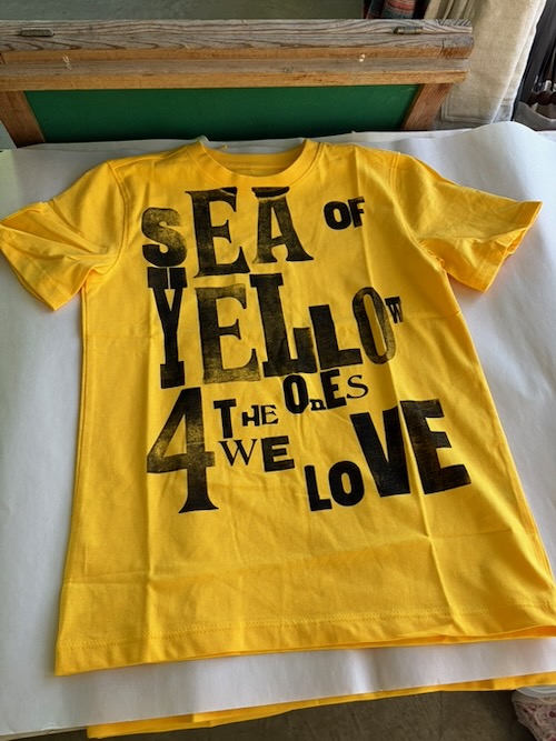 Daffodil Day yellow T-shirt displaying the message “Sea of Yellow 4 the Ones We Love.”