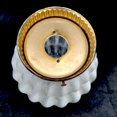 Vintage white textured glass lamp with a rounded ribbed design and brass-toned base fitting