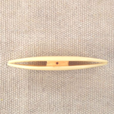 Cream-coloured vintage Paragon tatting shuttle with Paragon engraved on both sides