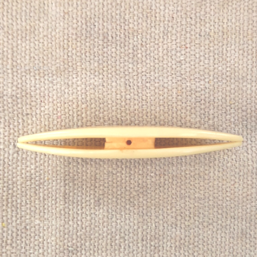 Cream-coloured vintage Paragon tatting shuttle with Paragon engraved on both sides