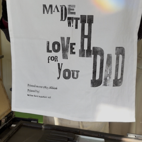 Father’s Day tea towel featuring the message “Made with love for you Dad,” printed using traditional wooden type.