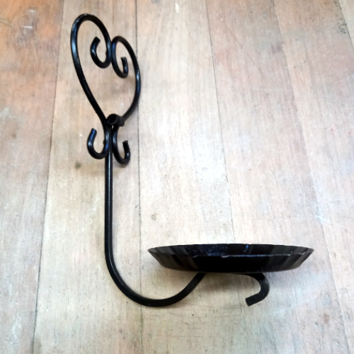 Genuine 1960s wrought iron wall plant holder displaying a potted spider plant