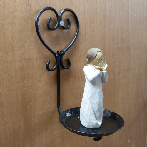 Genuine 1960s wrought iron wall plant holder displaying a potted spider plant
