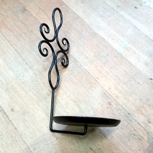 Genuine 1960s wrought iron wall plant holder displaying a potted spider plant