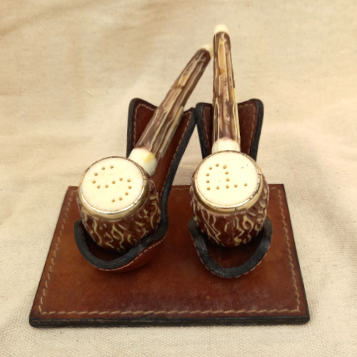 Vintage Grand Canyon Arizona salt and pepper shakers shaped like smoking pipes on a genuine leather stand