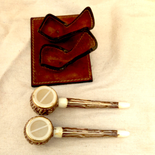 Vintage Grand Canyon Arizona salt and pepper shakers shaped like smoking pipes on a genuine leather stand