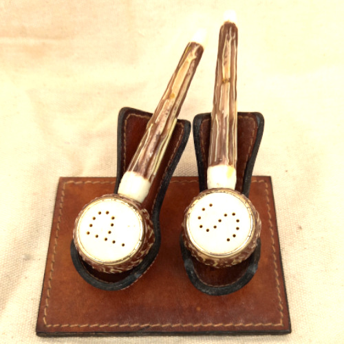 Vintage Grand Canyon Arizona salt and pepper shakers shaped like smoking pipes on a genuine leather stand