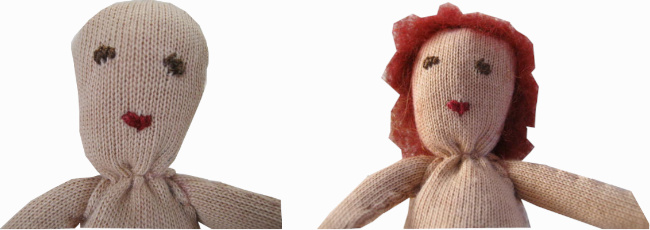 Handmade fabric doll with a stuffed head and body, pipe cleaner arms and legs, and fabric clothes