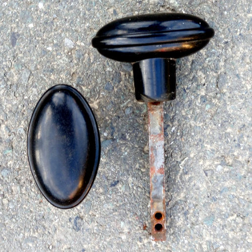 Pair of vintage oval rim lock door knobs with spindle and grub screws