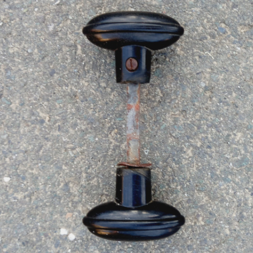 Pair of vintage oval rim lock door knobs with spindle and grub screws