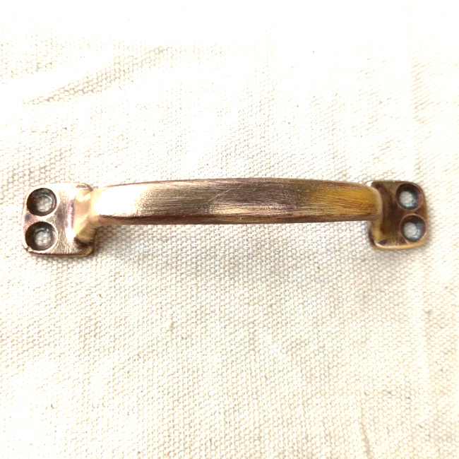 Vintage pull handle, most likely brass, with 104mm centre-to-centre fixing holes