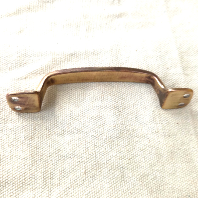 Vintage pull handle, most likely brass, with 104mm centre-to-centre fixing holes