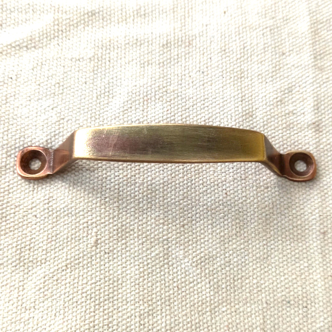 Vintage standard pull handle, possibly brass, with 88mm centre-to-centre spacing