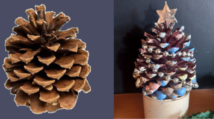 Handmade pine cone Christmas tree decorated with paint, glitter, tinsel and colourful beads on a festive base