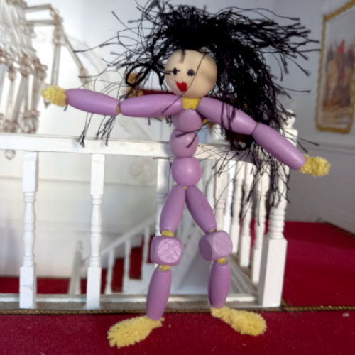 Handmade pipe cleaner person with a beaded body, wool hair and a painted bead face
