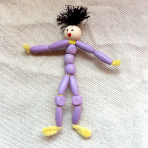 Handmade pipe cleaner person with a beaded body, wool hair and a painted bead face
