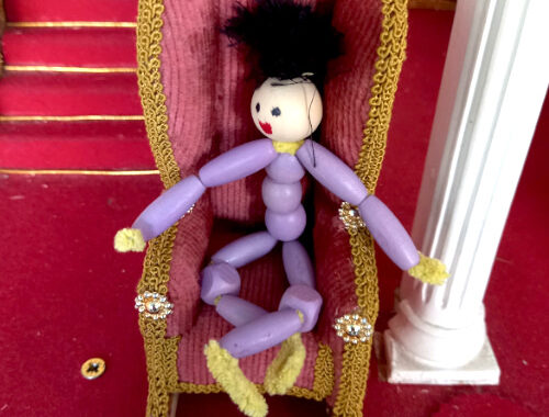 Handmade pipe cleaner person with a beaded body, wool hair and a painted bead face