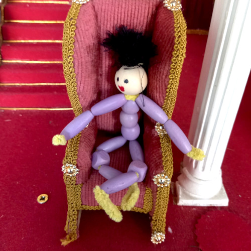 Handmade pipe cleaner person with a beaded body, wool hair and a painted bead face