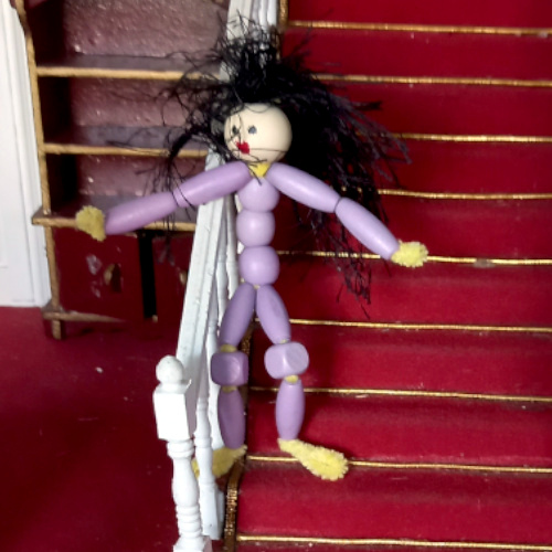 Handmade pipe cleaner person with a beaded body, wool hair and a painted bead face