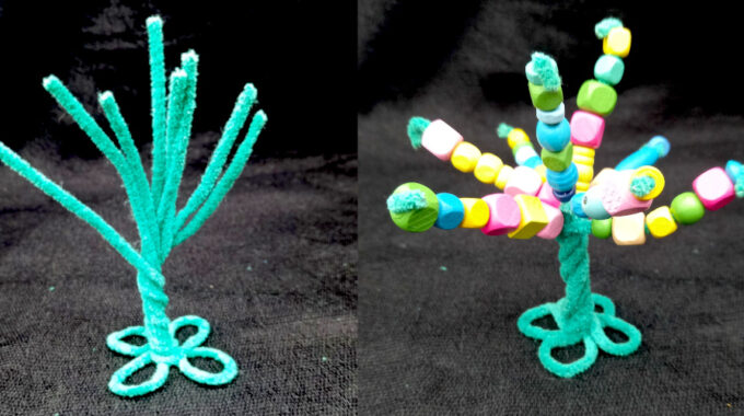 Handmade pipe cleaner tree decorated with wooden beads, with twisted branches and a base that stands upright.