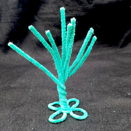 Handmade pipe cleaner tree decorated with wooden beads, with twisted branches and a base that stands upright.
