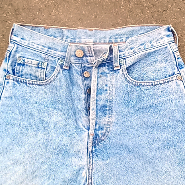 Vintage New Zealand-made Levi’s 555 straight leg jeans with red lowercase e tab and number 10 button stamp
