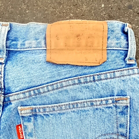 Vintage New Zealand-made Levi’s 555 straight leg jeans with red lowercase e tab and number 10 button stamp