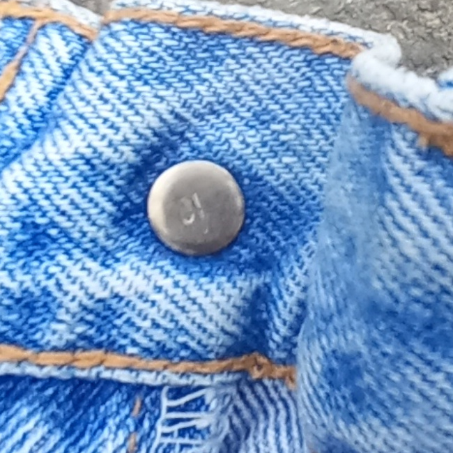 Vintage New Zealand-made Levi’s 555 straight leg jeans with red lowercase e tab and number 10 button stamp